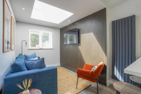 Bright and inviting living room featuring a lar...