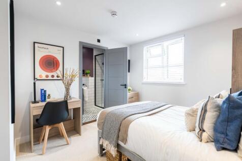 Bright and modern living room featuring a large...