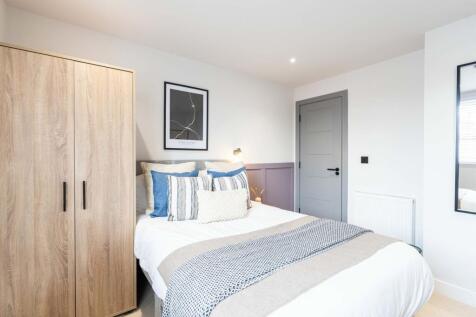 Bright and welcoming master bedroom featuring a...