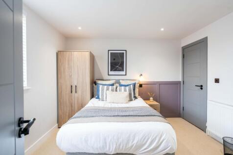A bright and inviting double bedroom featuring ...