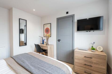 Bright and modern bedroom featuring a double be...