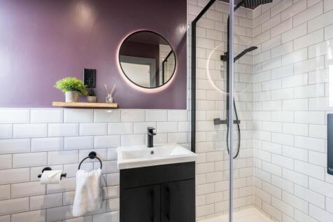 Modern bathroom featuring white subway tiles, a...