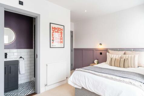 A modern and bright bedroom featuring a comfort...