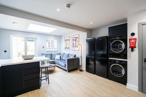 A modern, bright living room featuring a spacio...