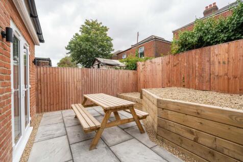 A well-maintained outdoor garden area featuring...