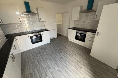 Bright and modern kitchen featuring dual oven s...