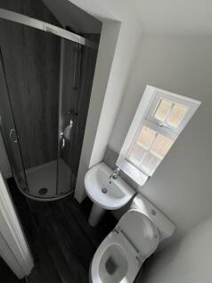 Compact and clean bathroom featuring a modern c...