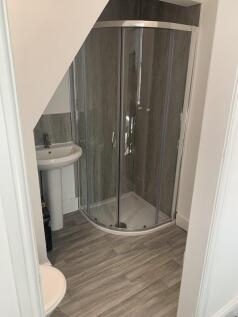 Modern bathroom featuring a corner shower enclo...