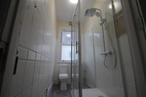 This modern bathroom features a stylish shower ...