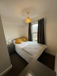 Cozy double bedroom featuring a comfortable dou...