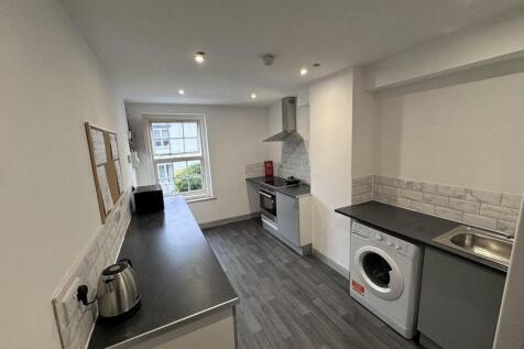 Bright and modern kitchen featuring sleek count...