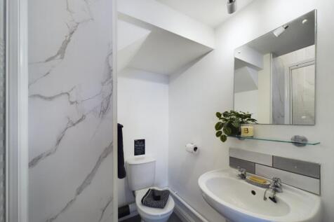 A modern bathroom featuring a large bathtub wit...