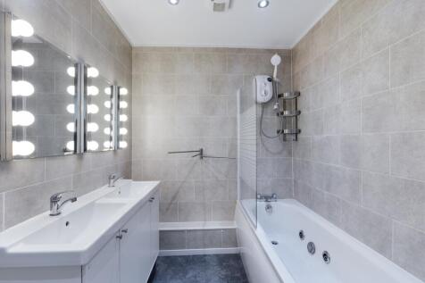 A spacious and modern bathroom featuring a luxu...