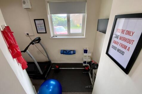 A bright and tidy gym space equipped for workou...