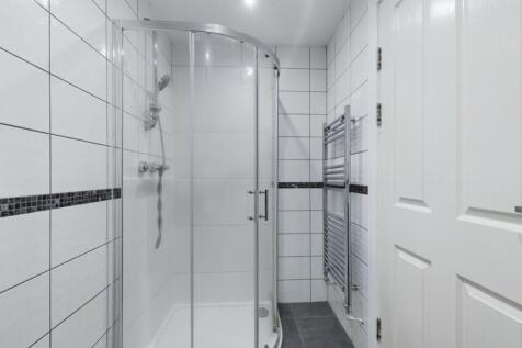 A modern and immaculate bathroom featuring a sp...