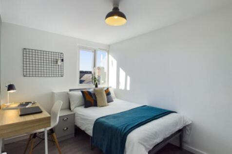 A bright and inviting double bedroom with moder...