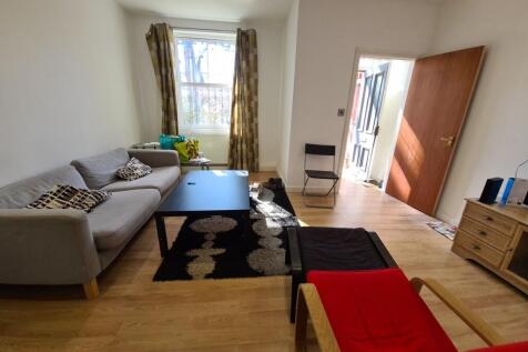 A spacious and welcoming living room featuring ...