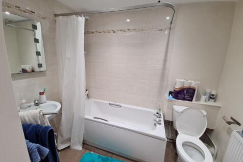 Bright and clean bathroom featuring a spacious ...