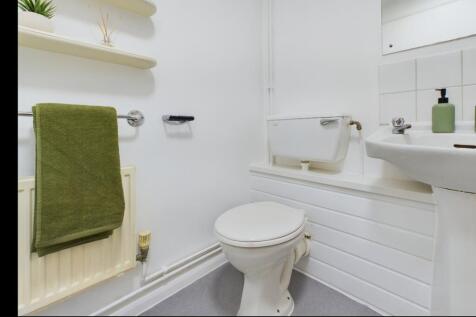 A tidy and well-maintained single toilet with m...