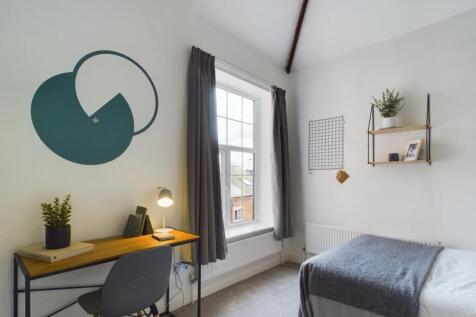 A bright and inviting double bedroom with moder...