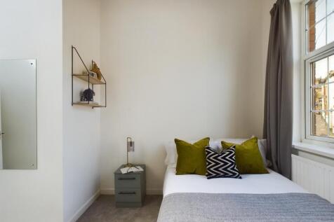 A bright and inviting double bedroom featuring ...