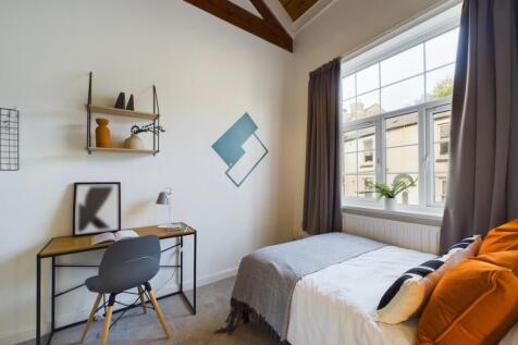 A bright and inviting double bedroom featuring ...