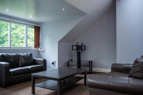 Spacious and bright living room featuring two c...