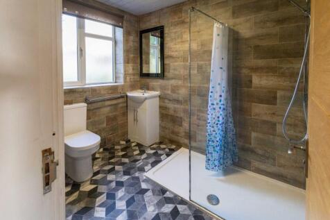 A modern bathroom featuring a large window prov...