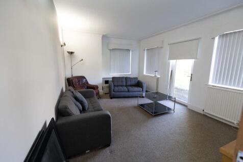 Bright and spacious living room featuring comfo...