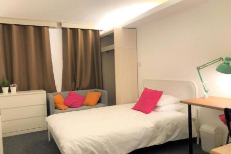 A cozy and tidy single bedroom featuring a comf...