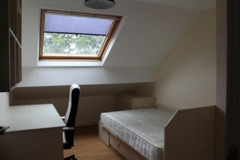 Bright and airy bedroom with a large skylight w...