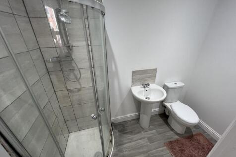 Bright and clean bathroom featuring a modern sh...