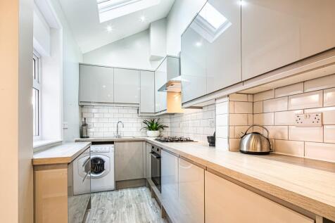 Modern, well-maintained kitchen featuring sleek...