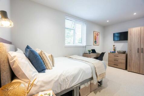 A bright and spacious master bedroom featuring ...
