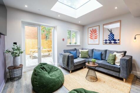 Bright and modern living room featuring a spaci...