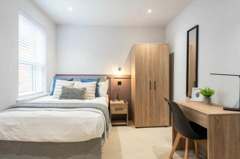 A modern, well-maintained bedroom featuring a c...