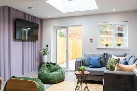 A bright and stylish living room featuring a co...