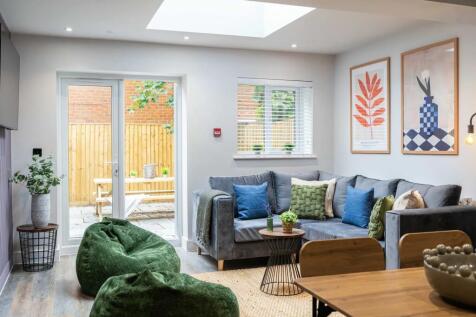 A bright and welcoming living room featuring a ...