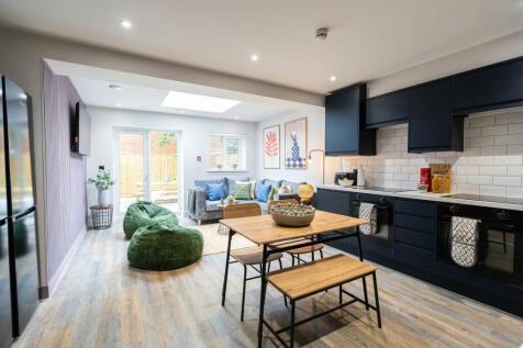 Bright and spacious living room featuring conte...