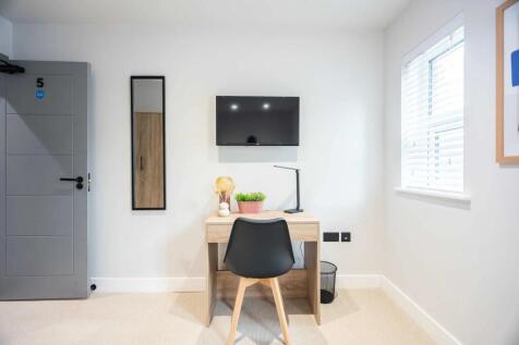 A well-lit, minimalistic study area with a wood...