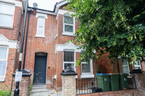 The exterior of a charming brick townhouse feat...