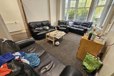 Spacious and welcoming living room with ample s...