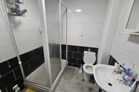 A clean and modern bathroom featuring a shower ...