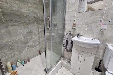 A modern bathroom featuring a shower enclosure,...