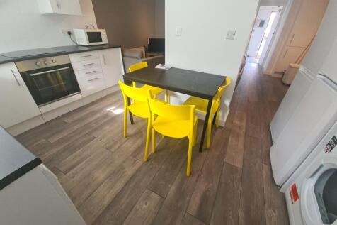 Bright and modern kitchen featuring white cabin...