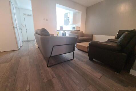 A cozy living room featuring modern sofas and w...