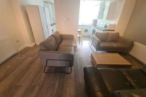 A cozy living room featuring comfortable sofas,...