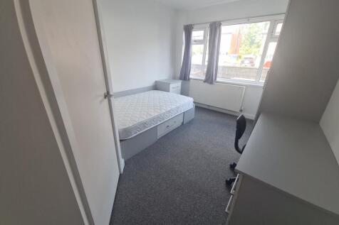 A clean and bright single toilet room with a wh...