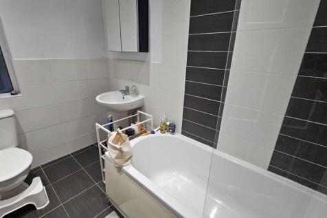 A modern bathroom suite featuring a clean white...