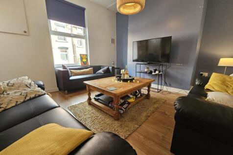 A cozy and stylish living room featuring comfor...